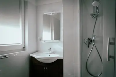 a bathroom with a sink and a shower at GuestHouse Aurora ML in Rome
