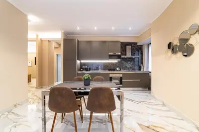 a kitchen with a dining room table and chairs at 50 Gandino Deluxe in Rome