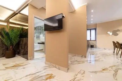 a lobby with a wall with a television on it at 50 Gandino Deluxe in Rome
