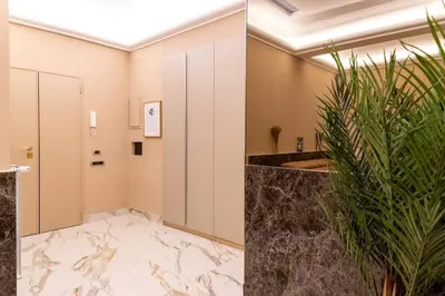 a bathroom with a large marble floor and a hallway at 50 Gandino Deluxe in Rome