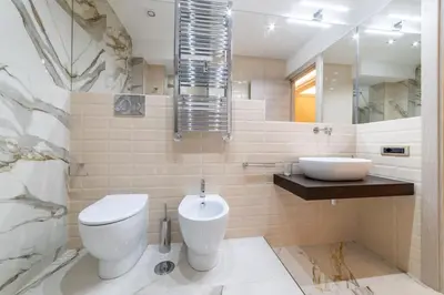 a white bathroom with a toilet and a sink at 50 Gandino Deluxe in Rome