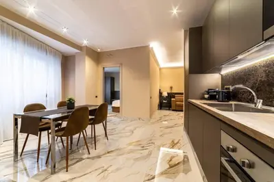 a kitchen and dining room with a table and chairs at 50 Gandino Deluxe in Rome