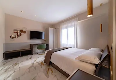 a bedroom with a bed and a tv on a marble floor at 42 Gandino Superior in Rome