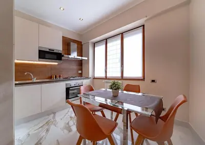 a kitchen with a dining room table and chairs at 42 Gandino Superior in Rome