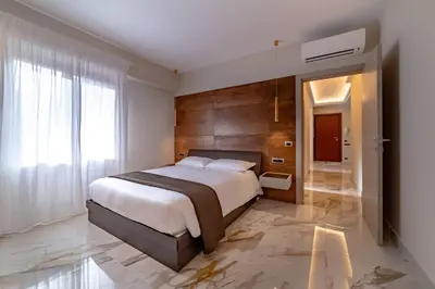 a bedroom with a large bed and a large window at 42 Gandino Superior in Rome