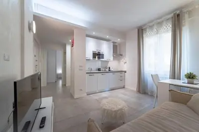 a kitchen and living room with a couch and a table at 35 Gozzadini in Rome