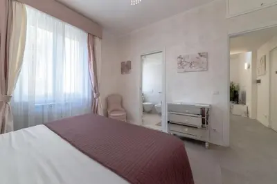 a bedroom with a bed and a window and a bathroom at 35 Gozzadini in Rome