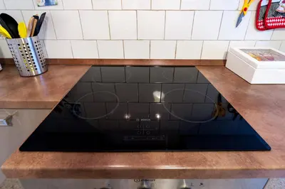 a stove top oven sitting under a counter in a kitchen at Ila Guest House in Rome