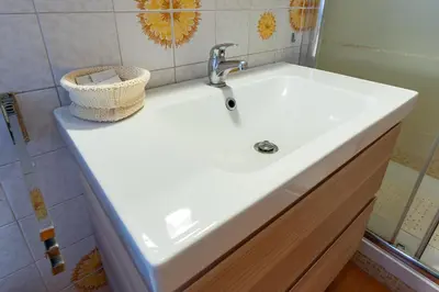 a white sink in a bathroom with a mirror at Ila Guest House in Rome