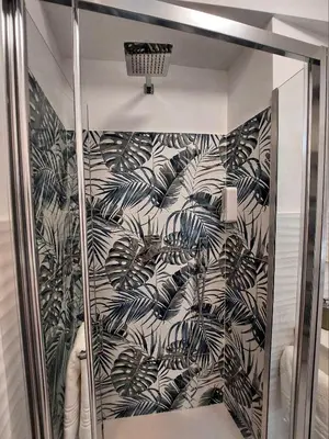 a shower stall with a black and white wallpaper at Tre Fiori in Rome