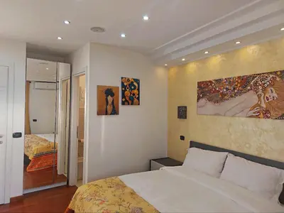 a bedroom with a bed and a painting on the wall at Tre Fiori in Rome