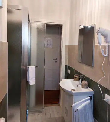 a small bathroom with a sink and a shower at Tre Fiori in Rome