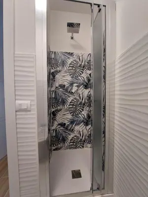 a glass elevator in a room with black and white wallpaper at Tre Fiori in Rome