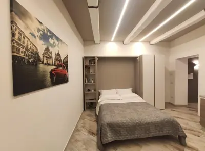 a bedroom with a bed and a painting on the wall at AlVin Casa in Rome