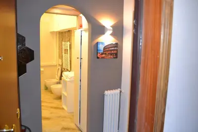 a bedroom with a bed and a picture of a red car at AlVin Casa in Rome