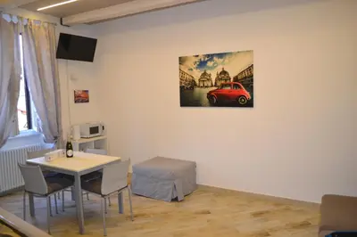 a room with a table and a red car on the wall at AlVin Casa in Rome