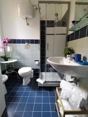 a bathroom with a toilet and a sink at Vatican Secret Rooms in Rome