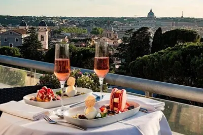 a table with two glasses of wine and food at Vatican Secret Rooms in Rome
