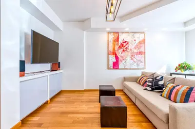 a living room with a couch and a flat screen tv at Trastevere, raffinato e silenzioso angolo in Rome
