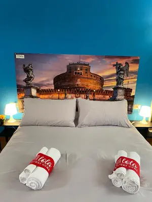 a bed with two cocacola mitts on top of it at Lola Holiday Home, Roma Ostiense in Rome