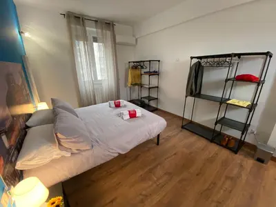 a bedroom with a bed and two shelves at Lola Holiday Home, Roma Ostiense in Rome