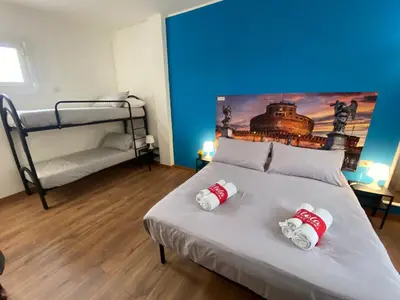 a bedroom with a bed with two bunk beds at Lola Holiday Home, Roma Ostiense in Rome