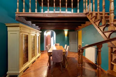 a dining room with a wooden table and a staircase at Appartamento Tor Millina 4 Piazza Navona in Rome