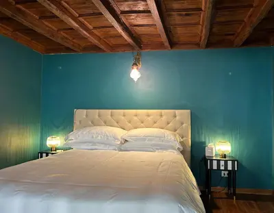 a bedroom with a bed with a blue wall at Appartamento Tor Millina 4 Piazza Navona in Rome