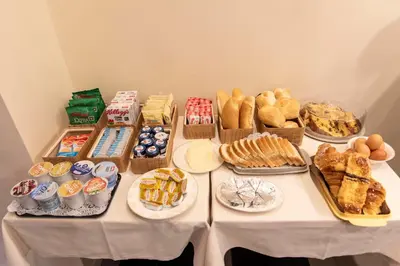 a table topped with lots of different types of pastries at Adelaide Suite Dreams in Rome