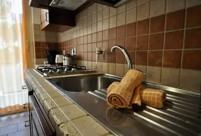 a kitchen sink with a faucet and two towels at Le 3 Elle Vaticano San Pietro in Rome