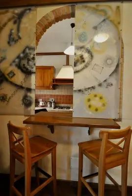 a kitchen with a table and two chairs and a mirror at Le 3 Elle Vaticano San Pietro in Rome