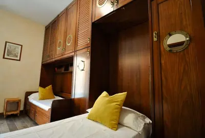 a bedroom with two beds and a wooden wall at Le 3 Elle Vaticano San Pietro in Rome