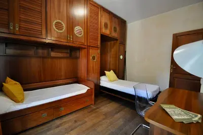 a small room with two beds and a table at Le 3 Elle Vaticano San Pietro in Rome