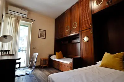 a bedroom with a bed and a desk with a chair at Le 3 Elle Vaticano San Pietro in Rome