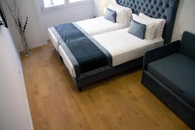 a bedroom with a large bed and a couch at Michelangelo Vatican Guest House in Rome