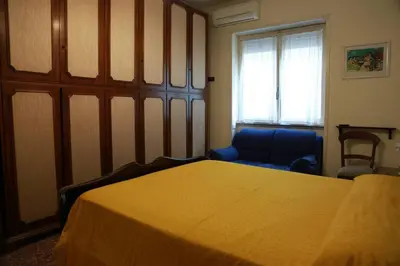 a bedroom with a bed and a chair and a window at San Peter’s Heaven’s Door in Rome