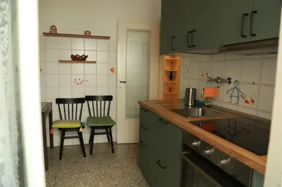 a kitchen with two chairs and a counter and a sink at San Peter’s Heaven’s Door in Rome