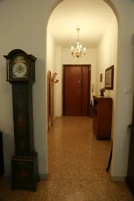 a hallway with a grandfather clock in a room at San Peter’s Heaven’s Door in Rome