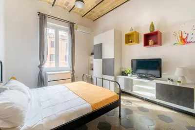 a bedroom with a bed and a flat screen tv at Casetta Giolitti, Cozy Apt in the Heart of Rome in Rome