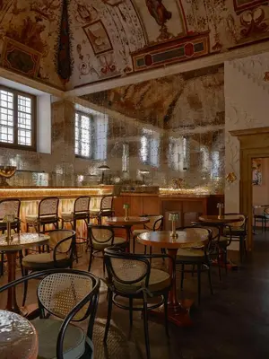 a restaurant with tables and chairs in a room at Palazzo Talìa - Small Luxury Hotels of the World in Rome
