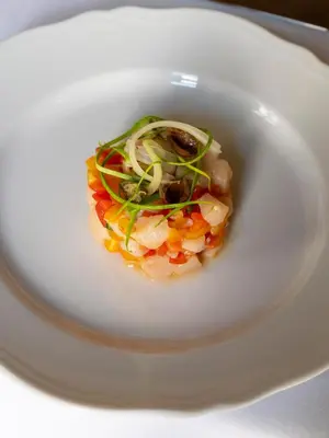 a white bowl of food with shrimp and vegetables at Palazzo Talìa - Small Luxury Hotels of the World in Rome