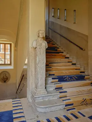 a statue of a woman standing on the stairs at Palazzo Talìa - Small Luxury Hotels of the World in Rome
