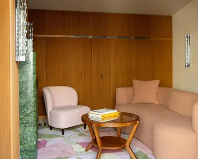 a living room with a couch and a chair and a table at Palazzo Talìa - Small Luxury Hotels of the World in Rome