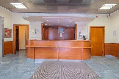 a court room with a wooden bench in a building at Hotel Monte Verde in Rome
