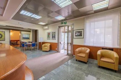 a waiting room with chairs and a table in a hospital at Hotel Monte Verde in Rome