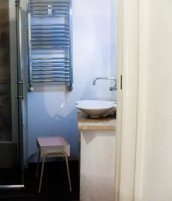 a bathroom with a sink and a stool at DGVatican in Rome