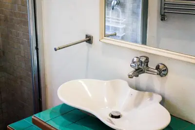 a white sink in a bathroom with a mirror at DGVatican in Rome