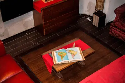 two books on a table with a candle in a living room at DGVatican in Rome