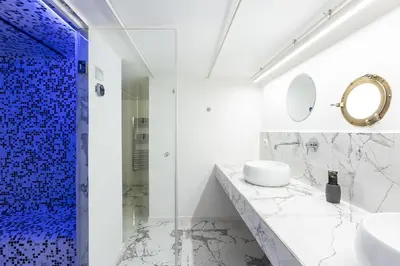 a bathroom with a shower and a sink and a mirror at Colosseo View Atmosphere by Rental in Rome in Rome