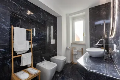 a bathroom with a sink and a toilet and a tub at Colosseo View Atmosphere by Rental in Rome in Rome